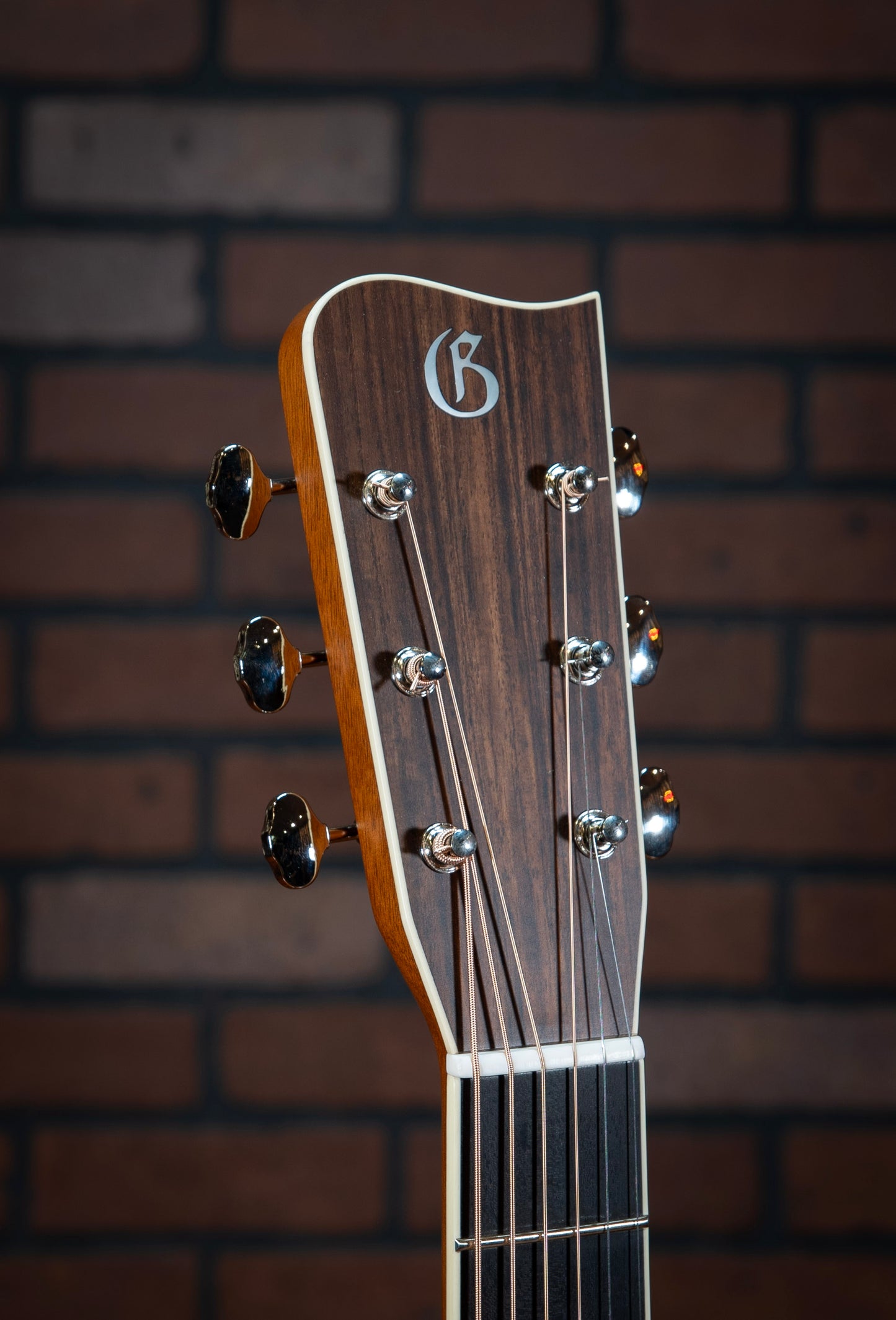 Gallagher Doc Watson Model acoustic guitar headstock with mother-of-pearl inlays, vintage aesthetic, and jumbo frets.