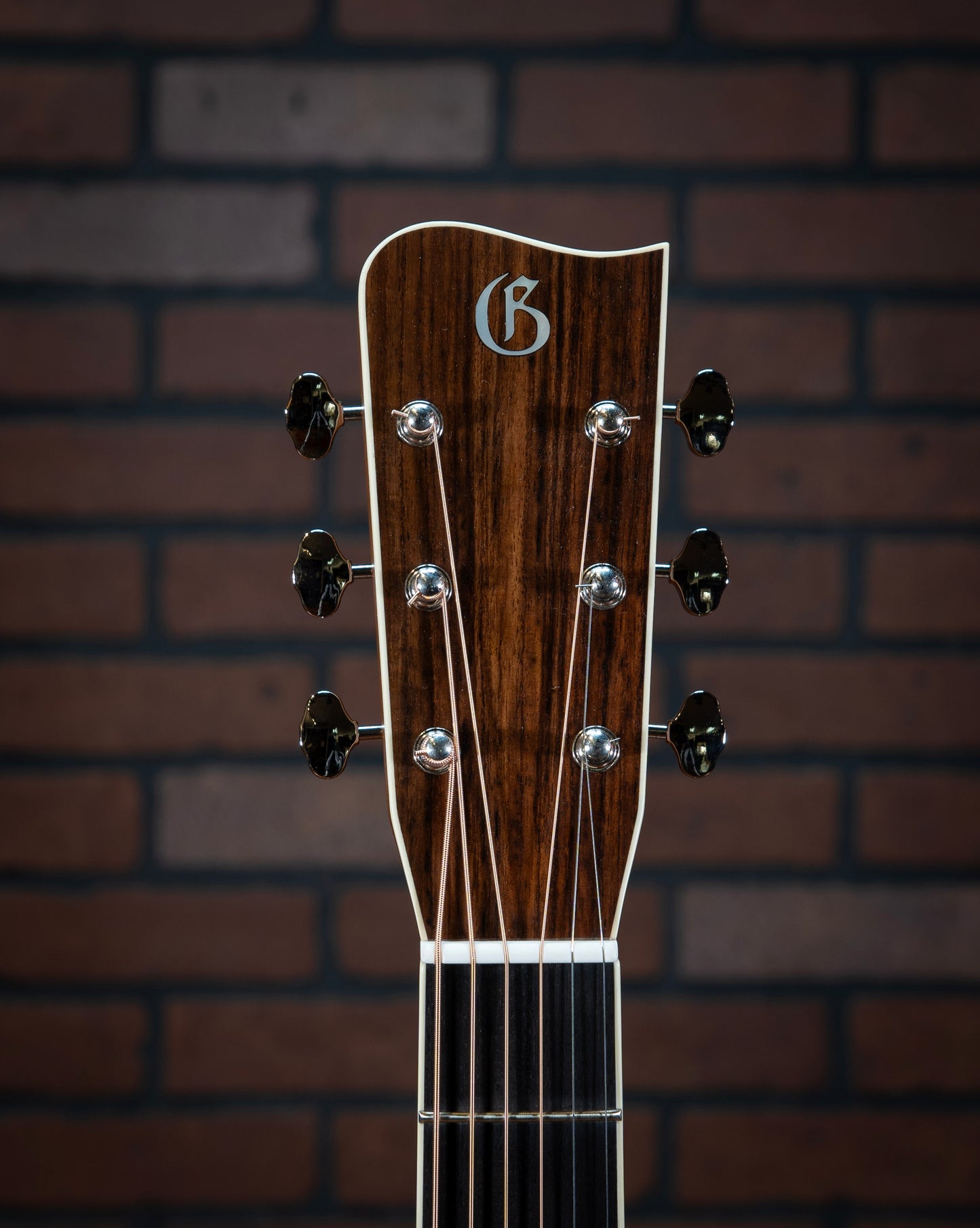 Gallagher Doc Watson Model acoustic guitar wave headstock and neck with ivoroid binding, jumbo frets, mother-of-pear inlays, and vintage aesthetic.
