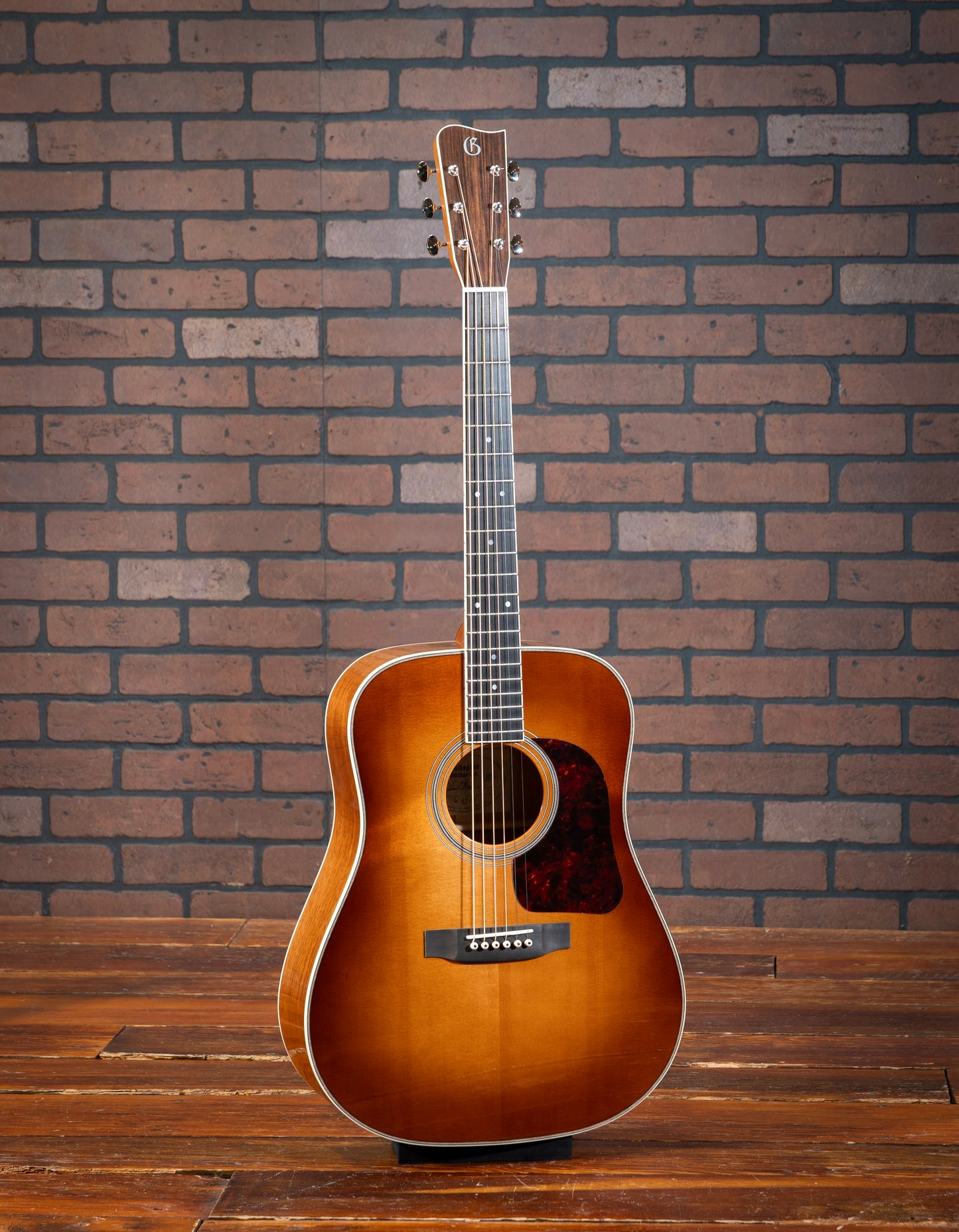 Gallagher Doc Watson Model acoustic guitar with Sitka spruce sunburst top, Mahogany sides, dreadnaught body, jumbo frets, and vintage aesthetic.