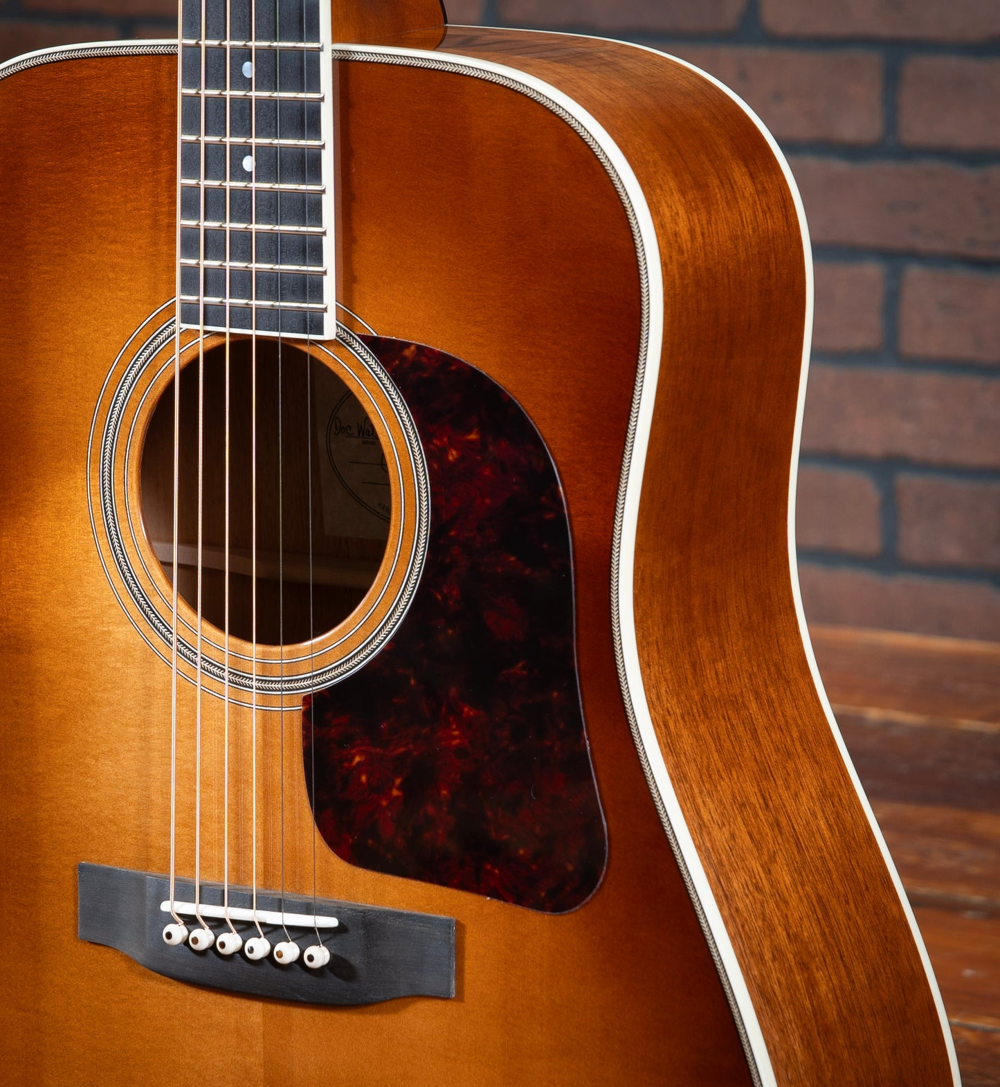 Gallagher Doc Watson Model acoustic guitar with ivoroid binding, herringbone purfling, and mother-of-pearl dot inlays with jumbo frets.
