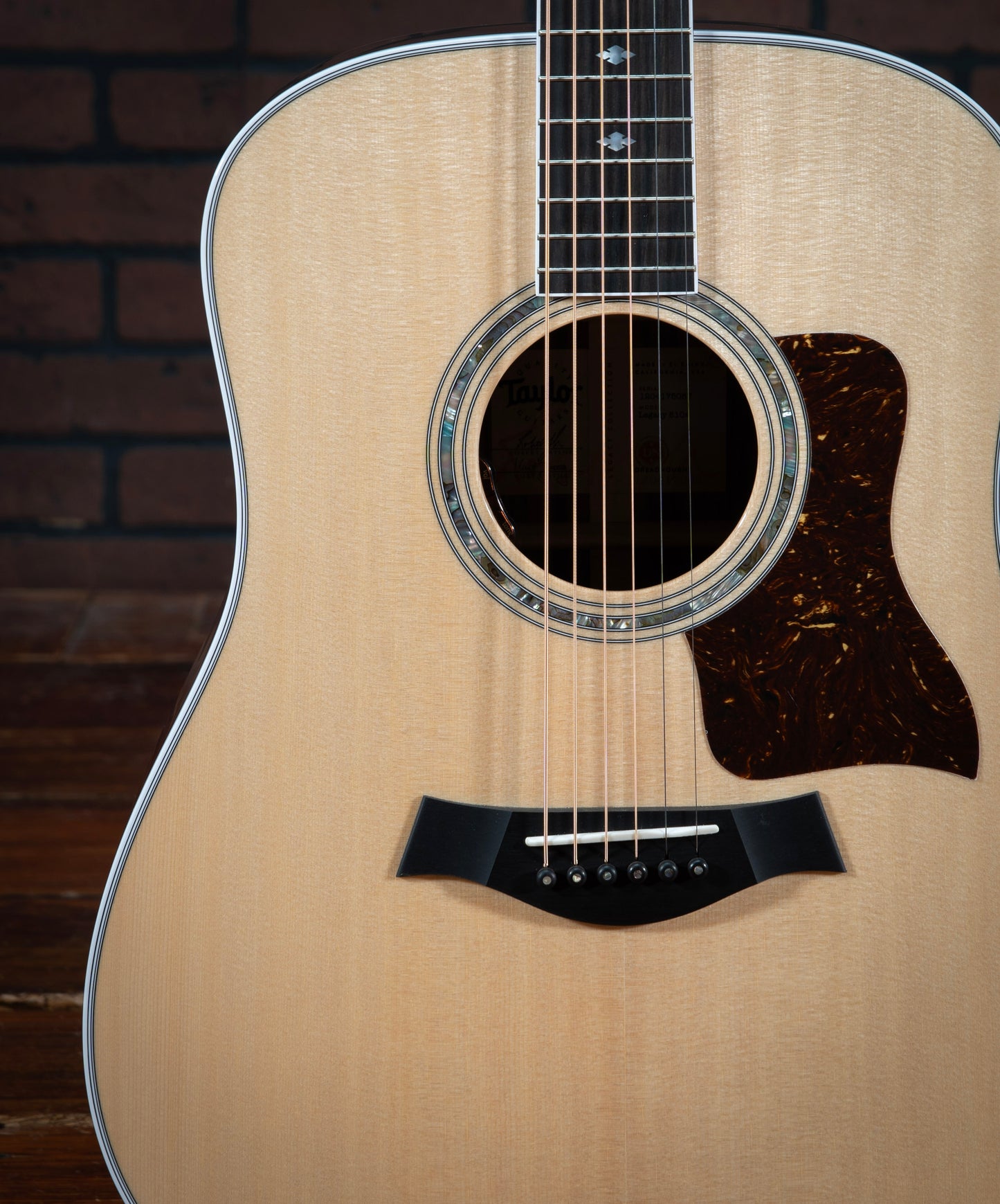 Taylor Legacy 810e acoustic electric guitar with faux tortoiseshell pickguard, green abalone rosette, and ebony bridge pins with green abalone dots