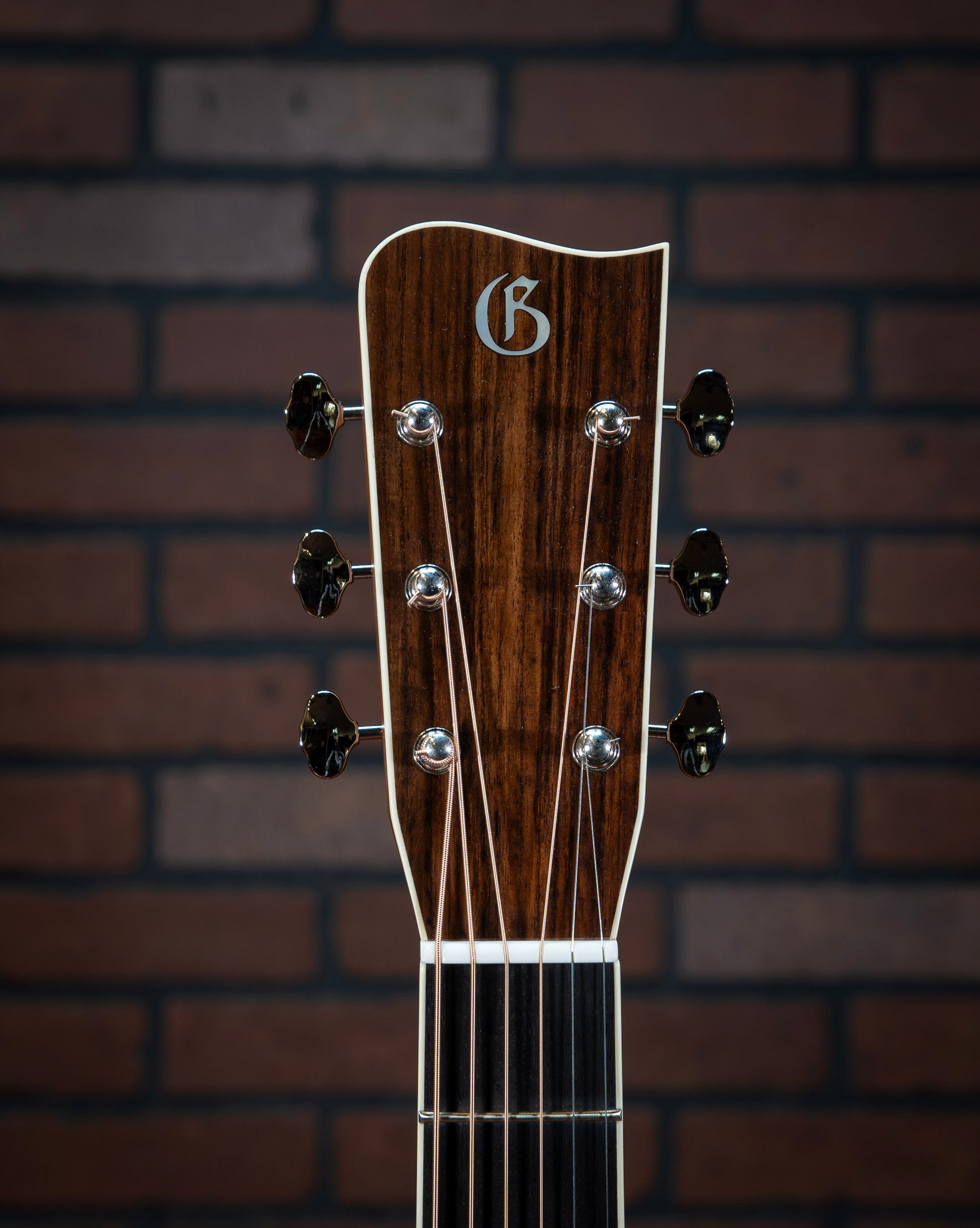 Gallagher Doc Watson Model acoustic guitar wave headstock and neck with ivoroid binding, jumbo frets, mother-of-pear inlays, and vintage aesthetic.