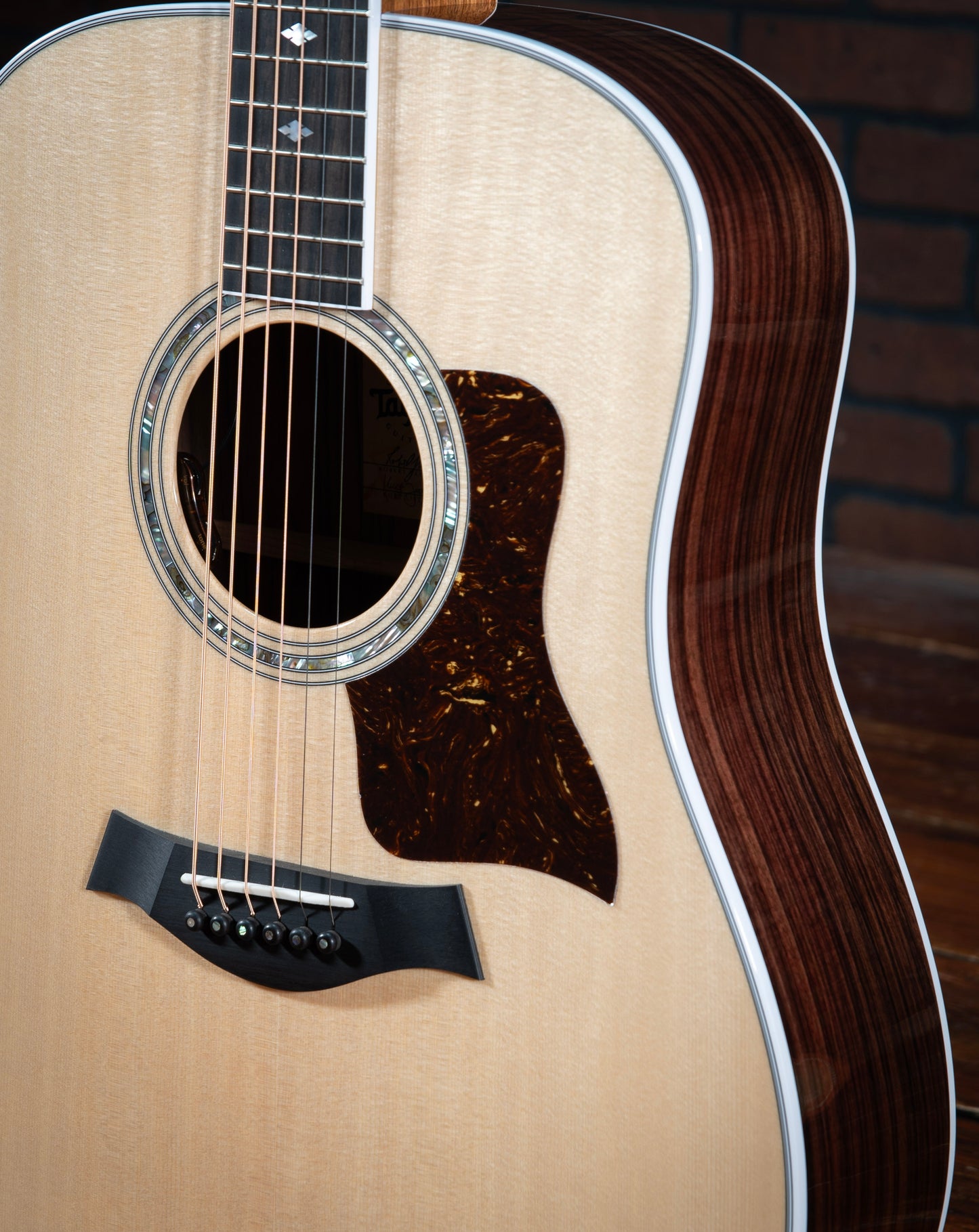 Taylor Legacy 810e acoustic electric guitar with Indian rosewood sides, white binding, faux tortoiseshell pickguard, and 3 ring rosette. 